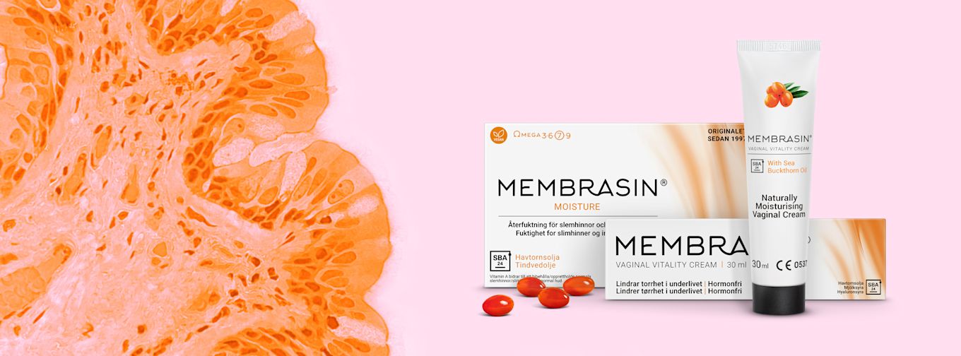 Förpackning och tub av Membrasin vaginalkräm med havtornsolja, kapslar och apelsinmönstrad bakgrund på rosa yta.
